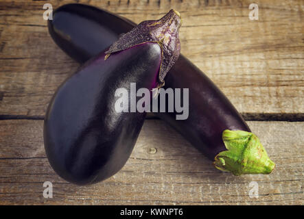 Two eggplant on an old wooden table. Stock Photo