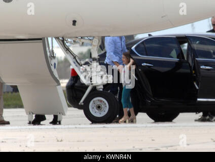 MIAMI, FL - MAY 17:  Suri Cruise seems to be a fashion diva wearing her high heels as she boards her private Gulfstream Jet. Dad Tom Cruise, and mom Katie Holmes accompanied Suri on her flight.  on May 17, 2011 in Miami , Florida.   People:  Tom Cruise Suri Cruise Katie Holmes Stock Photo