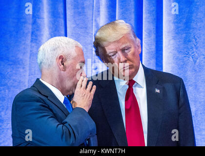 New York, USA, 11 January 2017.  US President-elect Donald Trump (R) listens to his Vice-President-elect Mike Pence before a news conference in New Yo Stock Photo