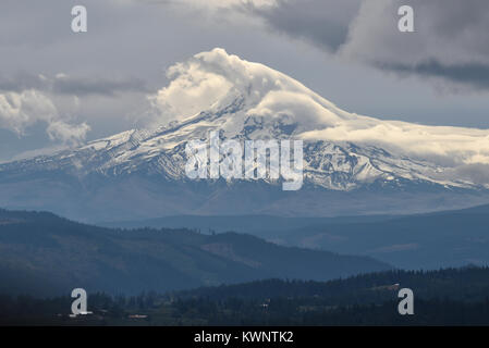 View of snow capped Mount Hood under interesting clouds taken from Washington state across the Columbia River to Oregon, USA Stock Photo