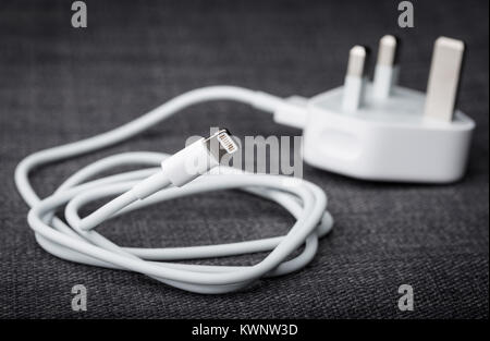 an iPhone cable with a UK plug for charging Stock Photo