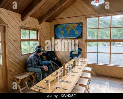 Trekkers relax in refugio; hut; lodge at El Chileno camp site; Torres Del Paine National Park; Chile Stock Photo