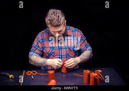 Leather Worker processes a workpiece from leather Stock Photo