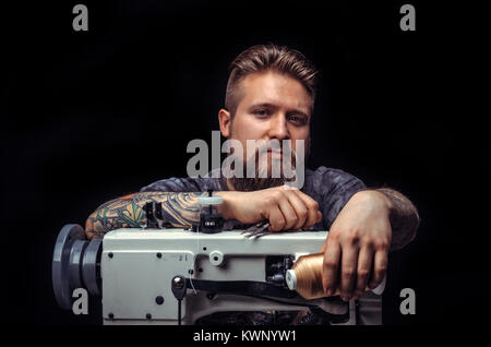 Leather Worker performs leather working for a new product Stock Photo