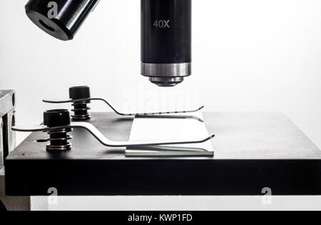 Microscope and microscope glass slide closeup macro, backlit, white background Stock Photo