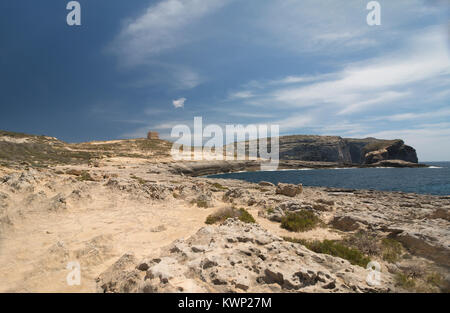 An image of a watchtower and the coastline at Dwerja Bay, Gozo, which is an island of the Maltese archipelago in the Mediterranean Sea. Stock Photo