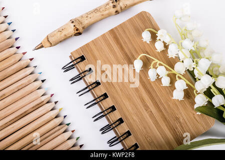 Notebook and pen made from sustainable bamboo or pine wood Stock Photo