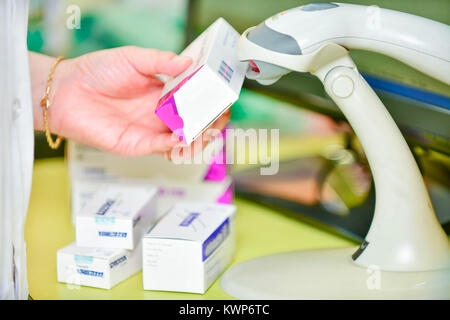 Pharmacist scanning barcode of medicine drug in a pharmacy drugstore. Stock Photo