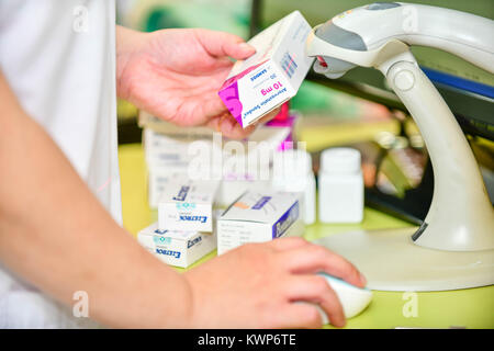Pharmacist scanning barcode of medicine drug in a pharmacy drugstore. Stock Photo