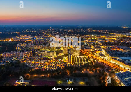 Aerial view of the illuminated Munich Olympic Village during sunset. The village was constructed for the 1972 Summer Olympics in Munich, Germany. Stock Photo