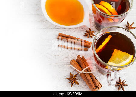 Honey,  tea with lemon and cinnamon sticks on a white background Stock Photo