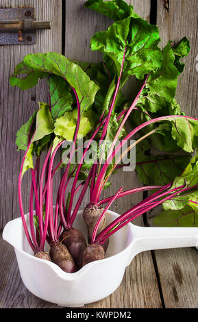 Organic Beets with foliage  on wooden background. Stock Photo