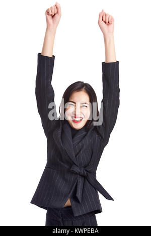 studio shot of a young asian business woman celebrating success, arms up, isolated on white background. Stock Photo