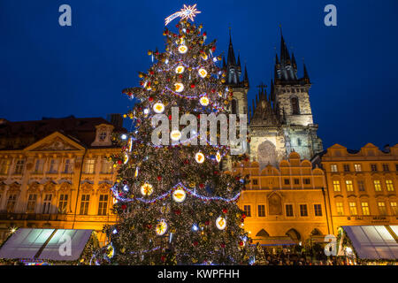 PRAGUE, CZECH REPUBLIC - DEC 21ST 2017: The Christmas tree and market in the Old Town Square in Prague, on 21st December 2017.  The towers of Tyn Chur Stock Photo