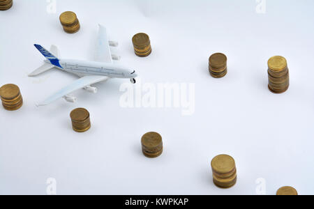 Plane plastic toy with coins isolated on white background Stock Photo