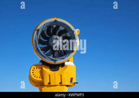 Snow gun machine waiting for frost with sun flare background