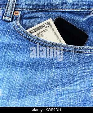 Blue Denim Jeans With Five Dollar Bills And A Smart Phone. Stock Photo