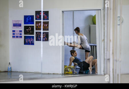Rock Island, Iowa, USA. 21st Mar, 2017. Professional ballet dancer Lauren Carmen warms up by stretching on the bar as Allegra Holland sits before starting a rehearsal at the Ballet Quad-Cities studio in Rock Island on Tuesday, March 21, 2017. Carmen, originally from Coalville, Iowa, is in her first year with Ballet Quad-Cities. Credit: Andy Abeyta, Quad-City Times/Quad-City Times/ZUMA Wire/17�Թ����� Live News Stock Photo