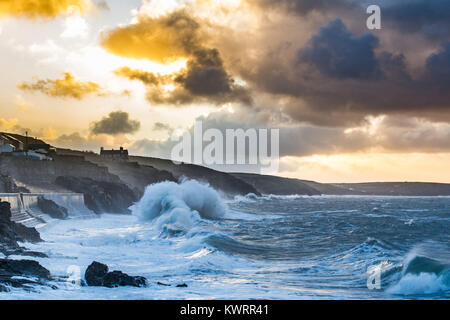 Porthleven, Cornwall, UK. 5th Jan, 2018. UK Weather. Westerly winds continue to push huge waves into Porthleven on the south west coast of Cornwall this morning at sunrise, before the winds swing round to the north east. The cliff path between Porthleven and Loe Bar is closed today due to a large cliff fall. Large waves are still causing ongoing damage. Credit: Simon Maycock/Alamy Live News Stock Photo