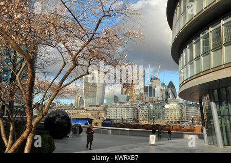 London, UK. 5th January, 2018. Early shows of blossom on the trees next to city hall on the south bank of the river Thames in London. Unusually warm climate for the time of year causing Blossom to show early in January on Trees in London with the city in the background. Credit: Steve Hawkins Photography/Alamy Live News Stock Photo