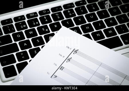 Music paper for strings instruments on a laptop Stock Photo