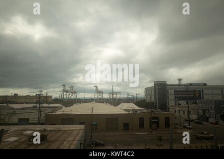 Gantry cranes and buildings are visible under a cloudy, ominous sky at the Port of Oakland in Oakland, California, September 13, 2017. Stock Photo