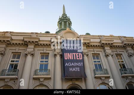 A large banner reading 'Berkeley Stands United Against Hate' hands on the Maudelle Shirek Building (aka Old City Hall) at Martin Luther King Jr Civic Center Park in Berkeley, California, part of a city-led response to 'alt right' organizations' 'anti Marxist' protests in the city, October 6, 2017. () Stock Photo
