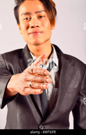 Indian male model extending a handshake towards camera, Pune, Maharashtra Stock Photo