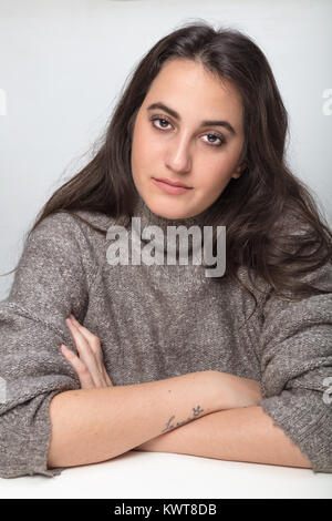 Series of portraits of a beautiful woman , Close up facial beauty portrait of an attractive young brunette woman looking with a serious expression int Stock Photo