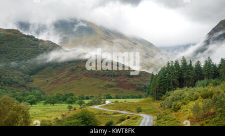 Mist rises into clouds from the slipes of Ben Nevis mountain in Glen Nevis in the West Highlands of Scotland. Stock Photo