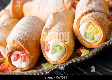 Italian cannoli dessert with a delicate cheese cream close-up on a plate. horizontal Stock Photo