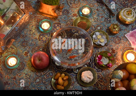 Nowruz - Iranian new year - Haftsin traditional culture tabletop arrangement in candlelight Stock Photo