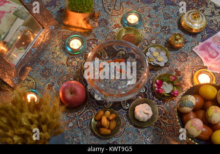 Nowruz - Iranian new year - Haftsin traditional culture tabletop arrangement in candlelight Stock Photo