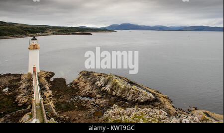 Kyle of Lochalsh, Scotland, UK - September 19, 2013: A lighthouse stands sentinel over the Kyle of Loch Alsh narrows on Eilean Bàn in the Highlands of Stock Photo