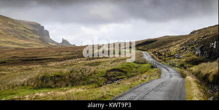 A single-track country road winds across wet mountain moorland at Quiraing on the Trotternish Peninsula of the Isle of Skye in the west Highlands of S Stock Photo