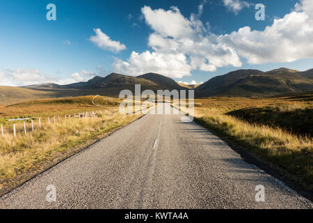 The A832 'Destitution Road' runs across moorland of The Fain towards the mountains of Fannich Forest in the northwest Highlands of Scotland. Stock Photo