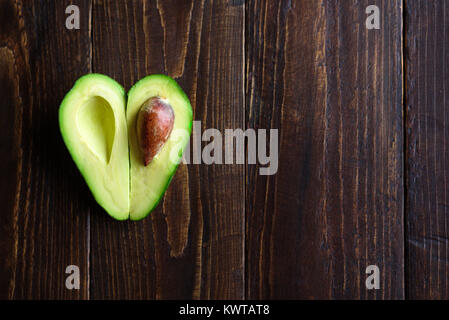 Fresh Cut Avocado With Heart Shaped Pit Area On Wooden Cutting Board  16444609 Stock Photo at Vecteezy