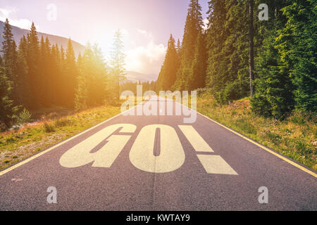 GO word on highway road in the mountains Stock Photo