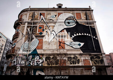 Also international artist took part in the Crono Project like the English contemporary artist Lucy Mclauchlan who decorated the facade of this old abandoned building at Rua Martens Ferrão in Lisbon. Portugal 2013. Stock Photo