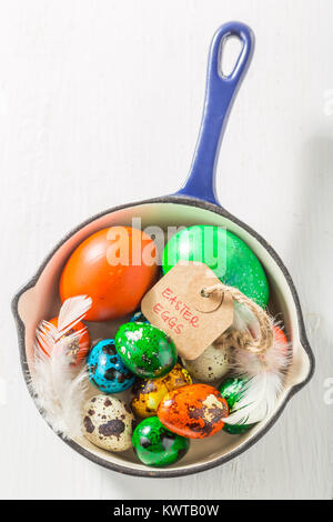 Top view of colourful Easter eggs in blue pan Stock Photo