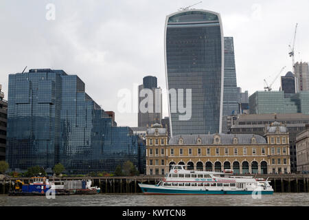 A ship docked on the River Thames by the Walkie Talkie Building (20 Fenchurch Street) in London, England. Stock Photo