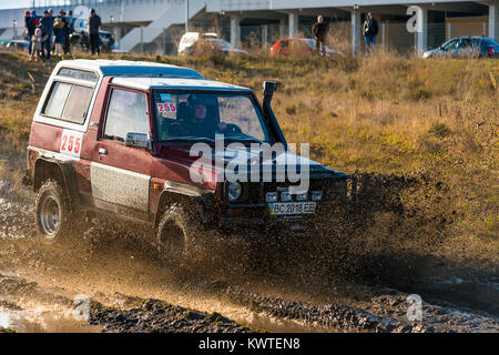 Lviv,Ukraine- December 6, 2015:Unknown rider on the off-road vehicle overcomes a route off road near the city of Lviv, Ukraine Stock Photo