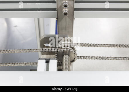 The Stainless gear and chain drive shaft in conveyor Stock Photo