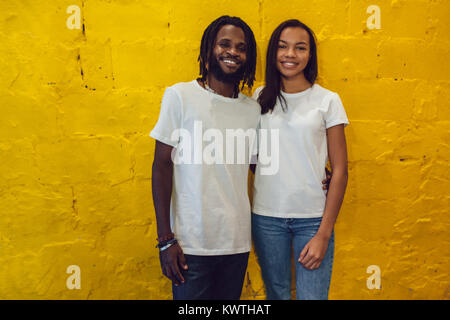 Beautiful African American couple in white t-shirts. Mock-up. Stock Photo
