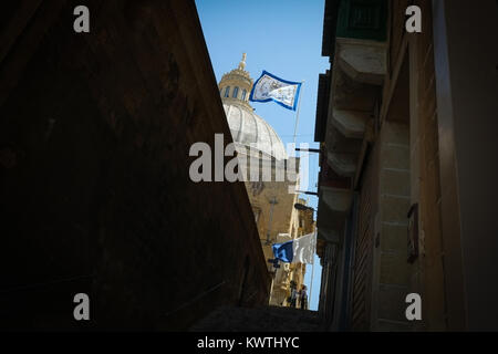 Valetta, Malta, European Capital of Culture 2018, Our Lady of Mount Carmel Church, city streets, with traditional religious sculptures and flags Stock Photo