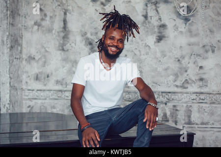 African American man with dreadlocks and a white T-shirt. Mock-up. Stock Photo