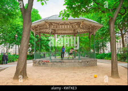 Children playing, view of two boys playing together in a bandstand in Boulevard Richard Lenoir in the Canal Saint-Martin area of central Paris, France Stock Photo