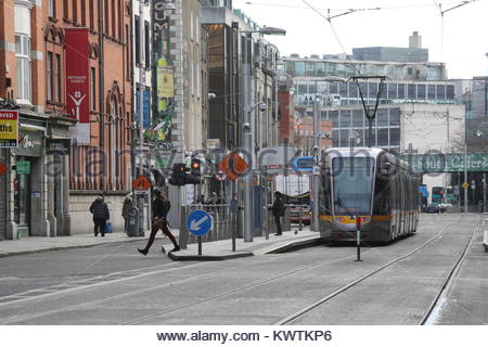 A Luas tram waits to pull away at a stop in Dublin city centre in Ireland Stock Photo