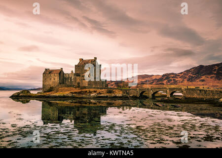 3th Century, Eilean Donan Castle taken on the Isle of Skye. Taken with a dramatic sky and reflection of the castle in the water. Stock Photo