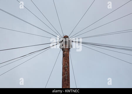 Telephone wires fanning out from a telegraph pole Stock Photo